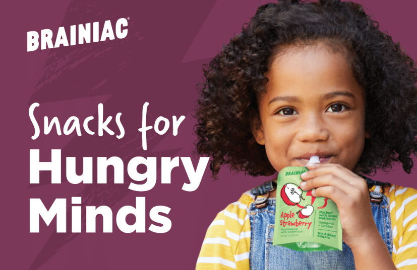 smiling girl eating from a Brainiac Kids pouch